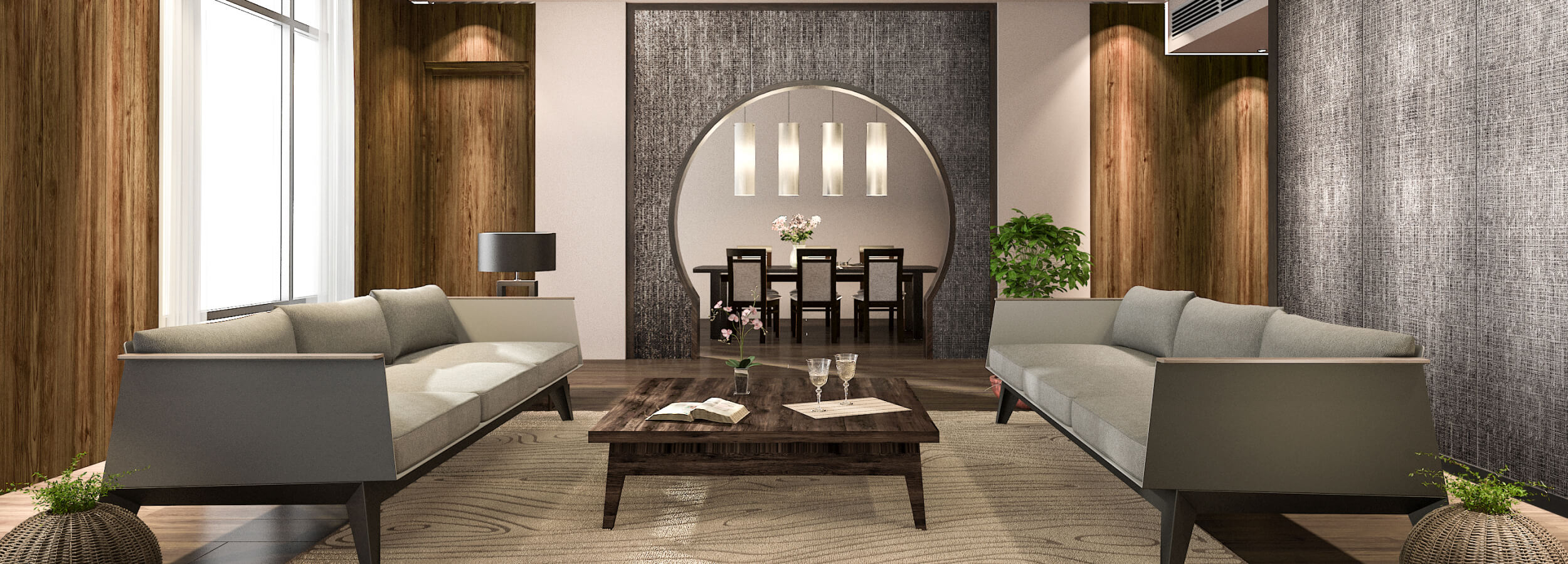 Modernes Wohnzimmer mit einer textilen Wandverkleidung, zwei grauen Sofas, einem Couchtisch und einem Essbereich, der durch einen Bogen sichtbar ist. Das Zimmer ist hell und freundlich durch große Fenster.