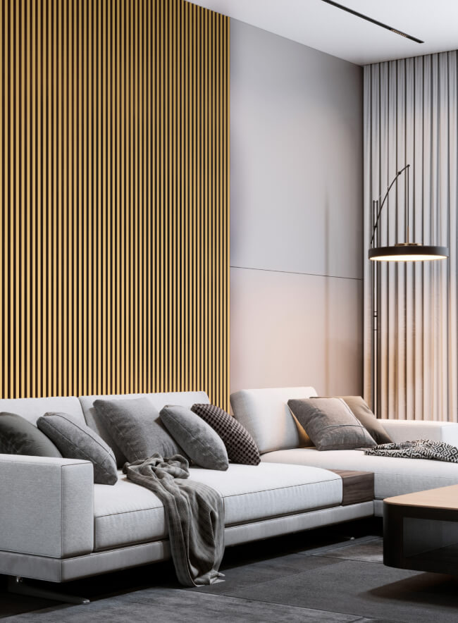 WallFace Akustikpaneele mit vertikaler Lamellenstruktur an einer Wohnzimmerwand mit grauer Couch